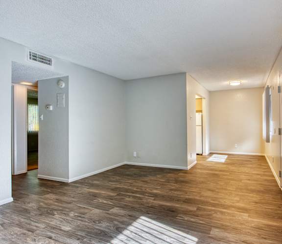 A room with wooden flooring and white walls. at The Link Apartments, Mesa, Arizona