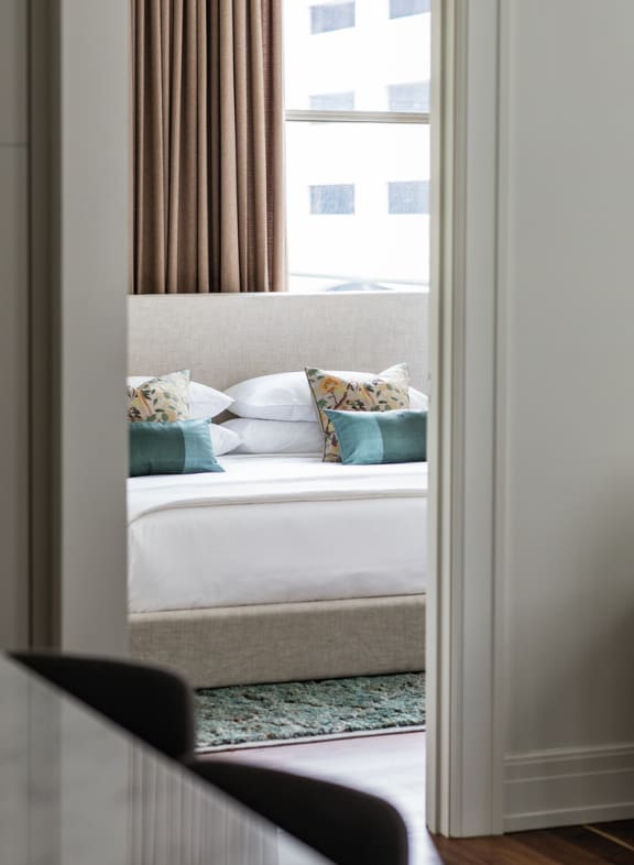 a bedroom with a large bed and a window