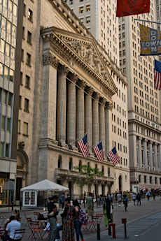 A large building with a lot of columns and a flag hanging from it.