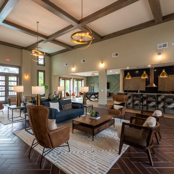 a large living room with couches and chairs and a fireplace