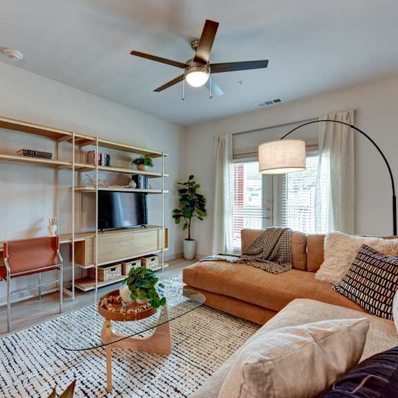 living room with sofa and glass table at Bridge at Saffron, Austin, TX