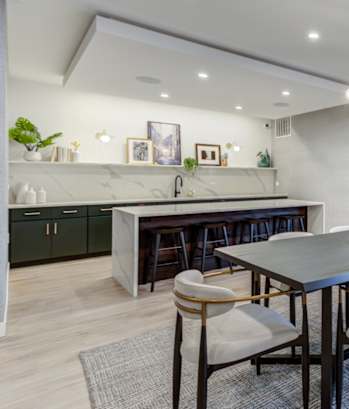 A modern dining room with a large table and chairs.