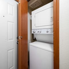 A white washing machine is in a small room.