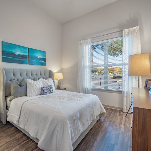 a bedroom with a bed and a desk with a chair