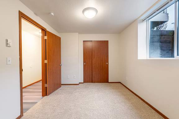 A room with two doors and a window.