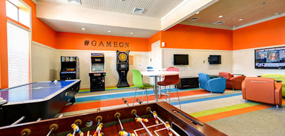 a recreation room with a pool table and a game room