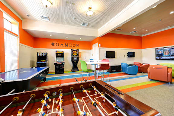 a recreation room with a pool table and a game room
