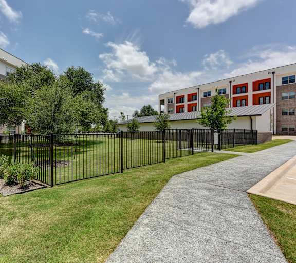 Outdoor garden with black fence at Bridge at Saffron, Austin, TX 78717