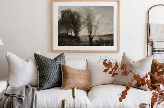 A living room with a white couch, a coffee table, and a framed picture on the wall at Balfour Marietta Apartments, Marietta, GA, 30060