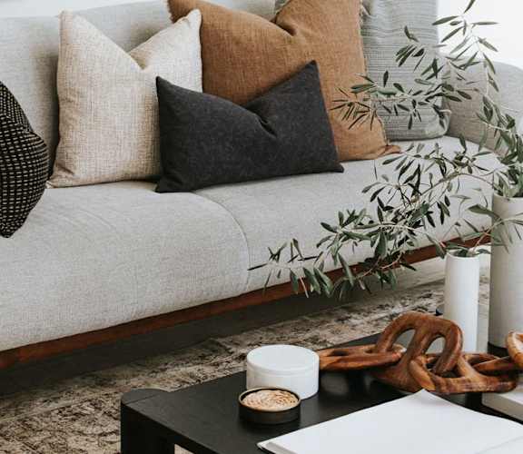 a living room with a couch and a coffee table with pillows at Woodbriar Management, LLC, Tucker, Georgia, 30084