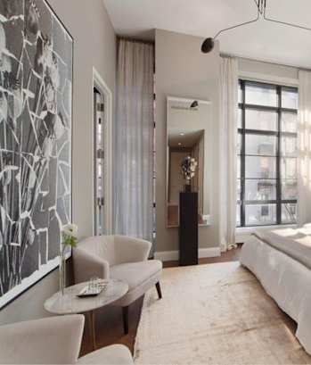 a bedroom with a bed sitting next to a window