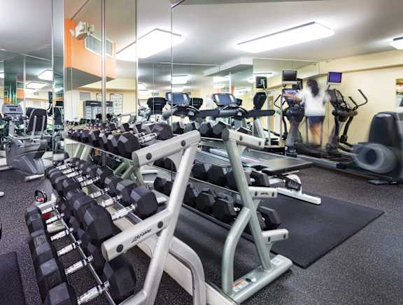 A gym with a variety of exercise equipment.