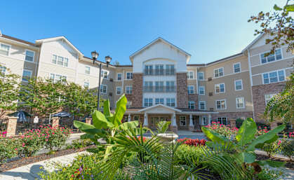 A large building with a garden in front of it.