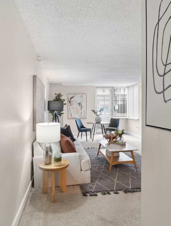 an open living room with a couch and a living room and a dining room