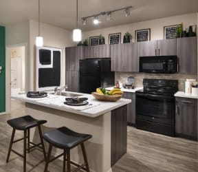 a kitchen with a large island with a marble countertop