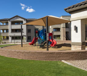a playground in a courtyard with apartments in the background