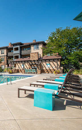 A large swimming pool with a building in the background.