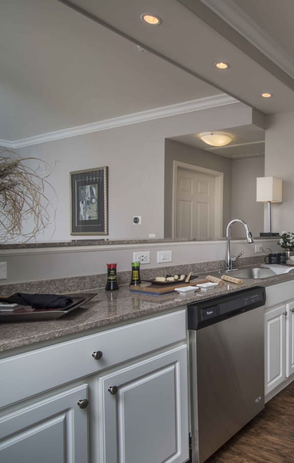 a kitchen with white cabinets and stainless steel appliances at The Sanctuary of Lake Villa, Lake Villa, IL