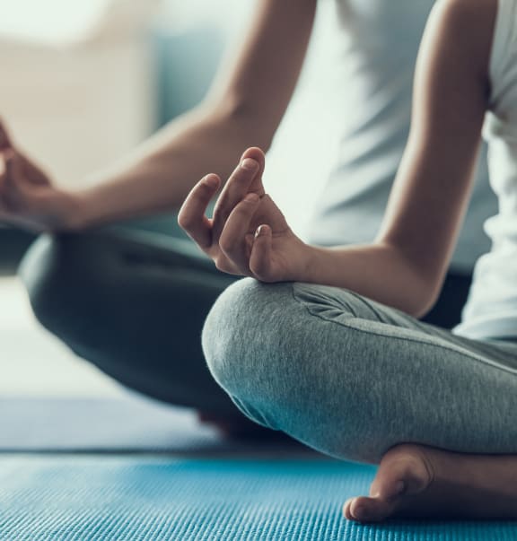 two people sitting on the floor in yoga poses
