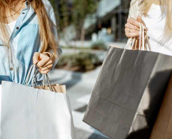 Two women carrying shopping bags.
