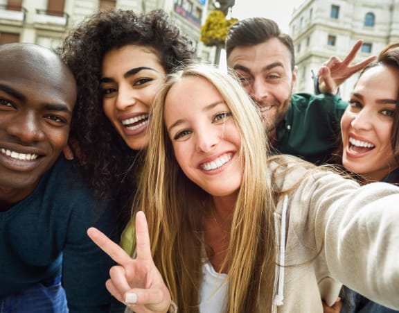 a group of young people posing for a picture together