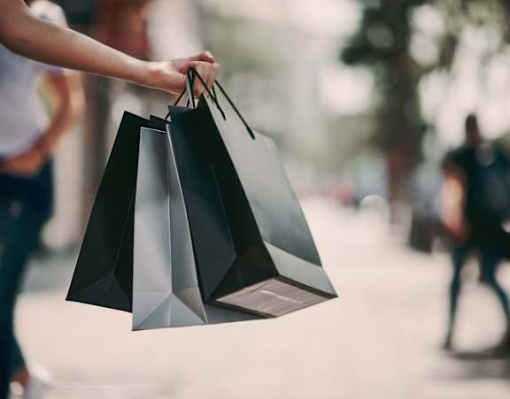 A person is holding three black shopping bags.at Palazzo Townhomes, Arizona