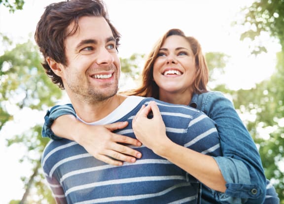 a man and woman laughing and hugging each other at The Falls of Portofino, Florida, 34119