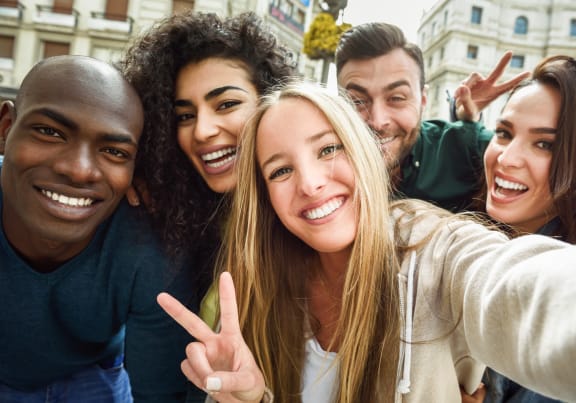 a group of people smiling and posing for a picture
