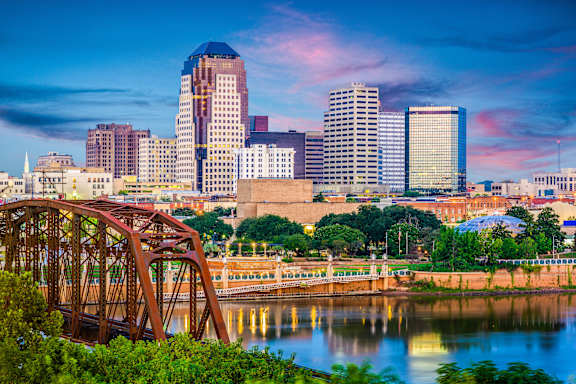 A cityscape with a bridge over a river.