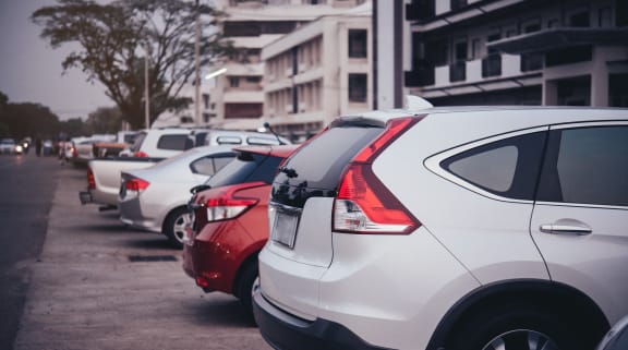 a row of cars parked in a parking lot