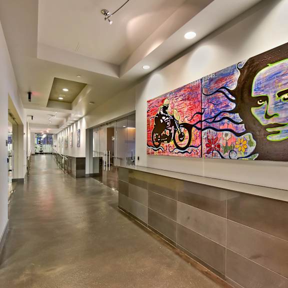 A hallway with a large painting on the wall.
