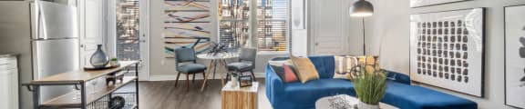 a living room with a blue couch and a table
