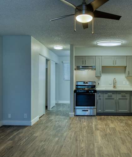 A kitchen with a wood floor and a ceiling fan. at The Link Apartments, Mesa, 85201