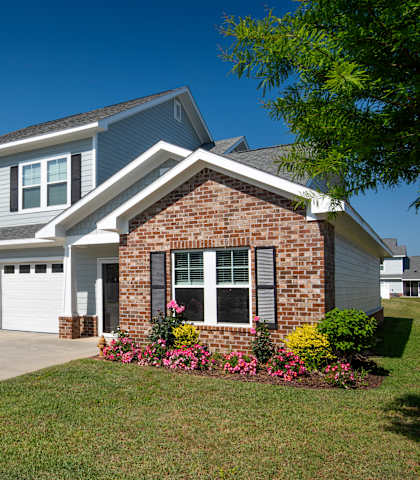 a house with a driveway and a garage door in front of it