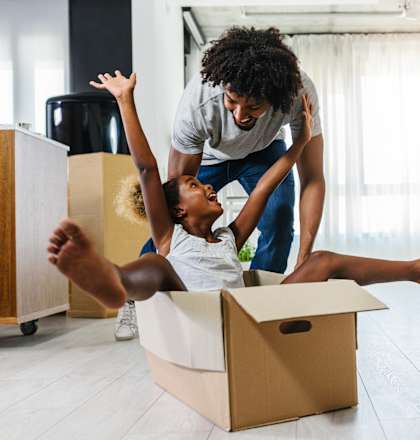 a man and a woman sitting in a box with a child