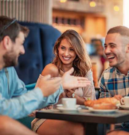 a group of people sitting around a table talking