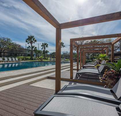 a pool area with lounge chairs and a pergola at Sunset Ridge, Texas, 78209