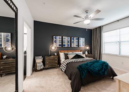 a bedroom with a bed and a ceiling fan