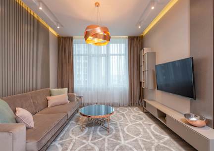 A modern living room with a sofa, coffee table, and television.