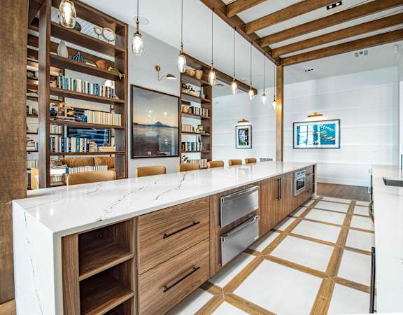 A modern kitchen with wooden cabinets and a white countertop.