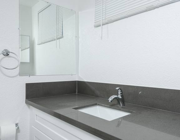 A bathroom with a sink and mirror.