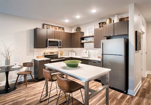A modern kitchen with a dining table and chairs.