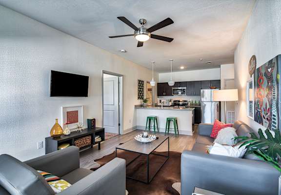 living room and kitchen with couches and a coffee table at Midtown Sam Houston Apartments, Huntsville, TX, 77340