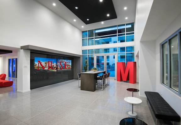 a lobby with a table and chairs and a large metro sign