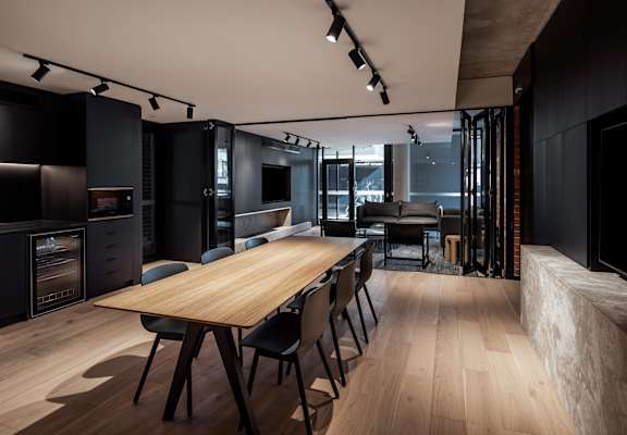a dining room and living room with a wooden table and chairs