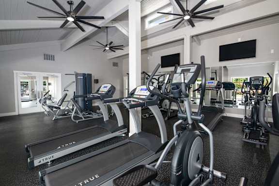 A gym with treadmills and exercise bikes.