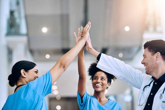 Three medical professionals giving each other high fives. at Park at Forest Hill Apartments, Tennessee