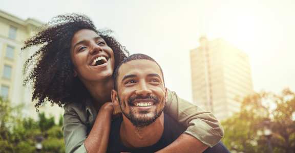 a man and a woman laughing in a city