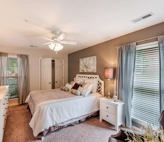 a bedroom with a large bed and a ceiling fan at Brittany Commons Apartments, Spotsylvania, VA, 22553
