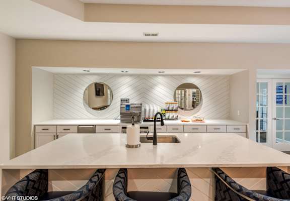 a large white kitchen with two sinks and two mirrors at Brittany Commons Apartments, Spotsylvania, VA, 22553